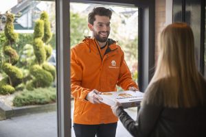 Takeaway.com delivery guy delivers pizza