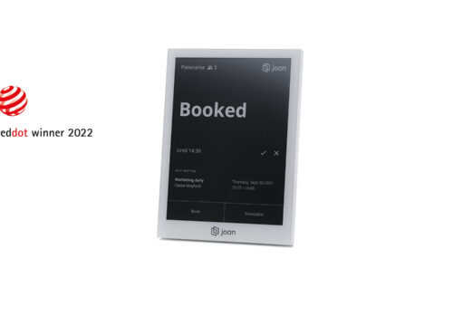 Joan 6 Pro e-ink display in gray showing a 'Booked' room status screen, Red Dot winner 2022 badge visible.