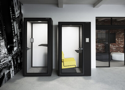 Two Koplus office acoustic pods with Joan 6 Pro e-ink displays mounted outside, in a modern open-plan workspace.