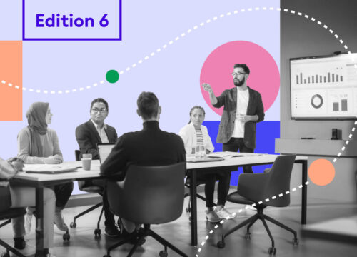 Diverse team in a meeting room with a presenter at a display screen, Edition 6 graphic overlay.