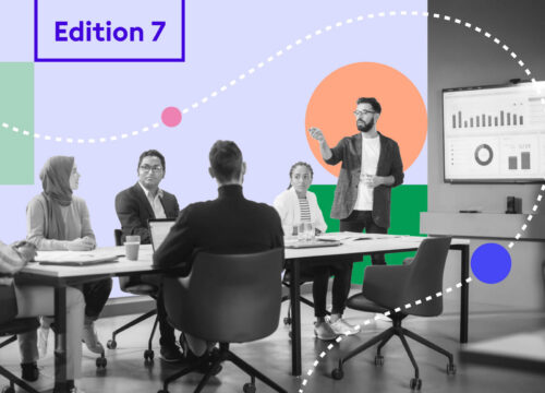 Diverse team in a meeting room with a presenter at a display screen, overlaid with colorful graphic shapes and 'Edition 7' label.