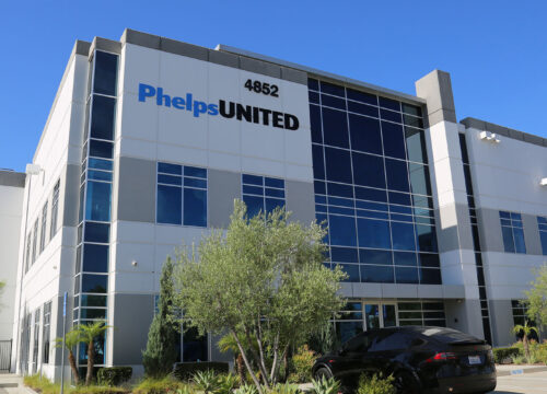 Exterior of the Phelps United office building at 4852, a modern two-story commercial structure with large glass windows.