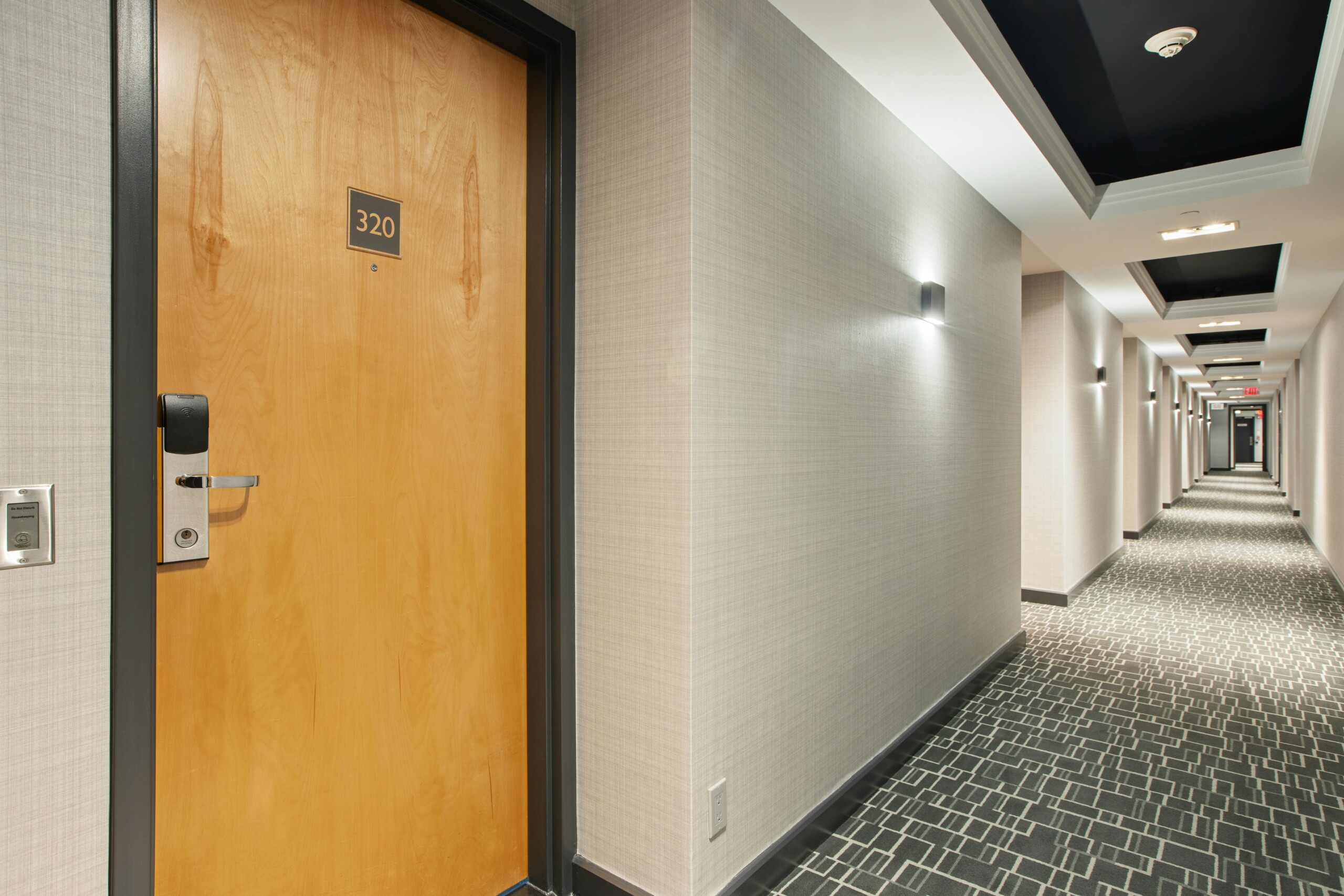 Modern hotel hallway with numbered guest room doors