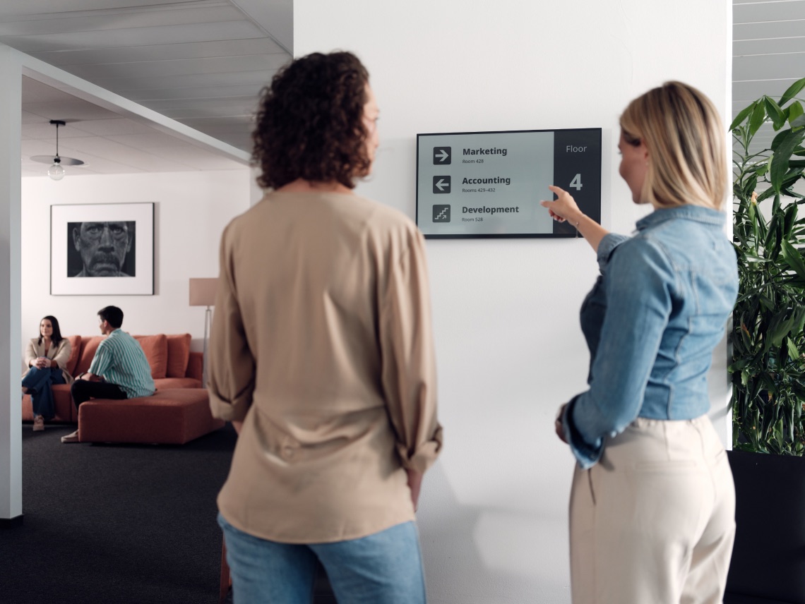 Joan digital signage display in an office corridor
