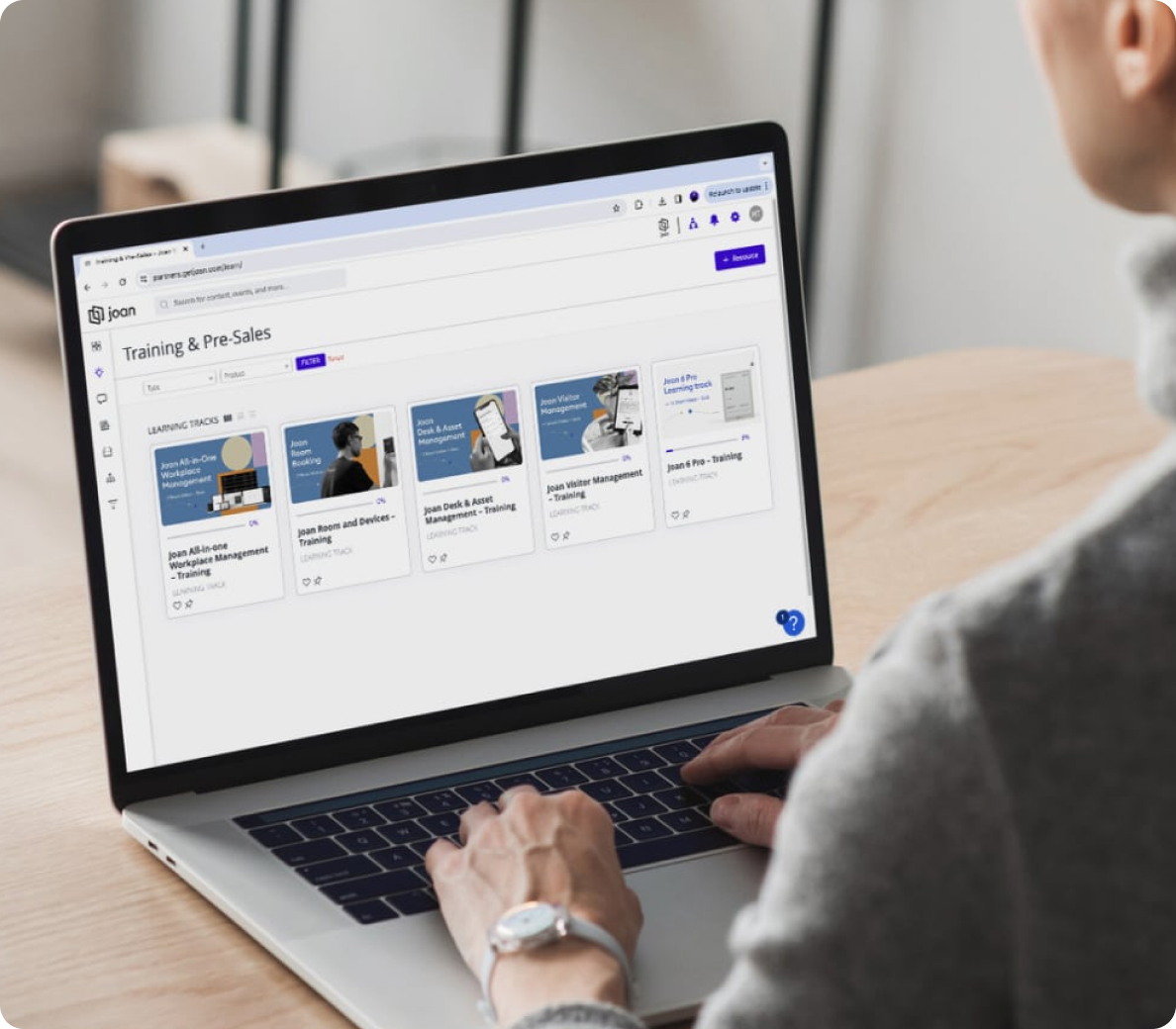 Joan Partner Portal training and pre-sales learning tracks open on a laptop