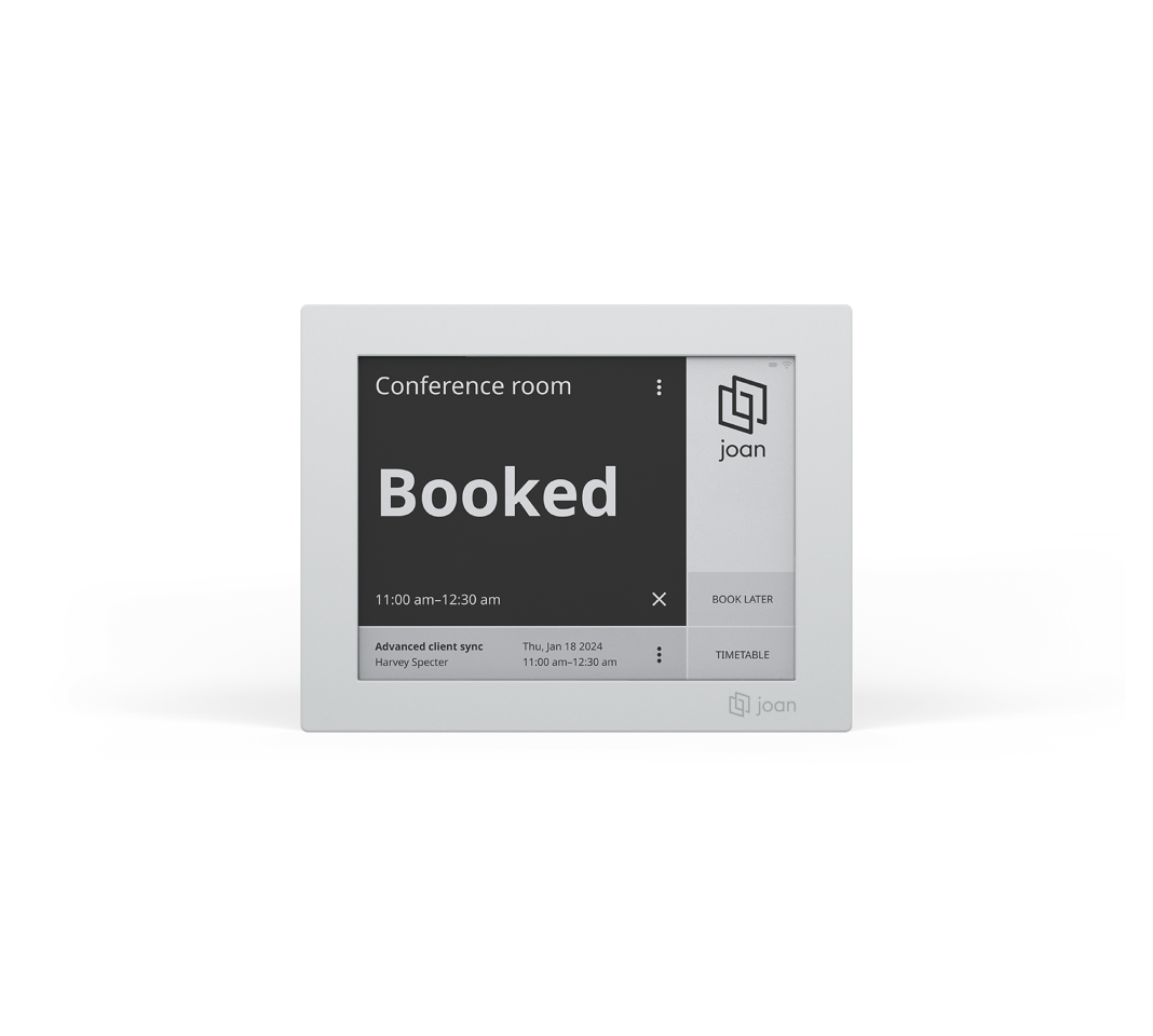 Joan 6 e-ink display showing a booked conference room with meeting details and booking options.
