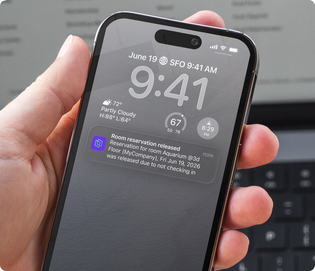 iPhone lock screen showing a Joan push notification that a room reservation was released due to no check-in.