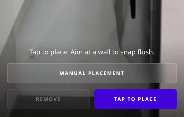 Joan app AR placement screen with 'Tap to place' instruction and manual placement and tap-to-place buttons.